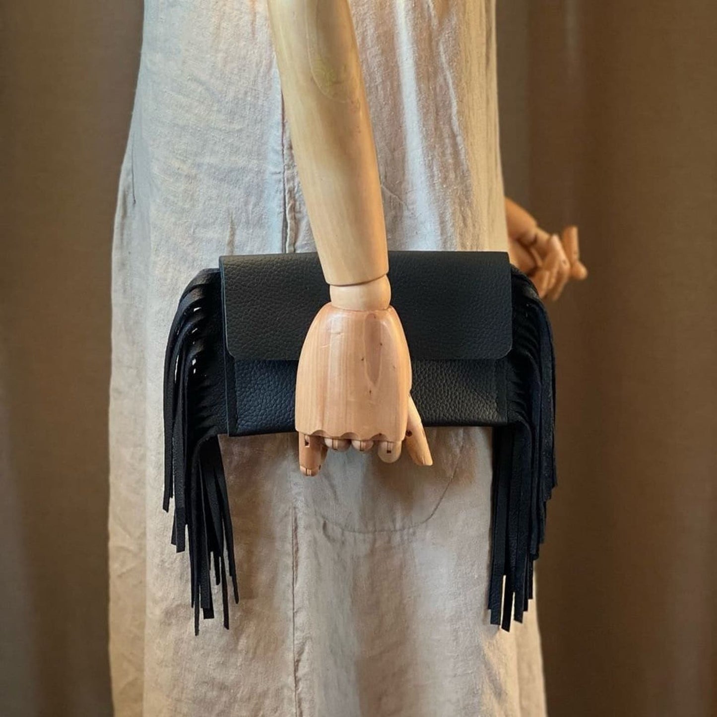 Sleek and Chic: Handcrafted Black Leather Fringe Clutch